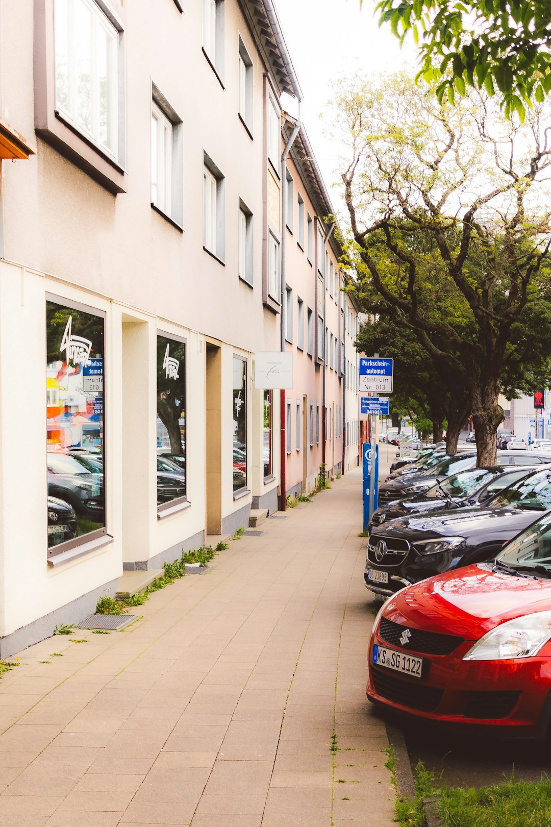 building-with-shop-fronts-and-parked-cars-1-a9jyr9cuk